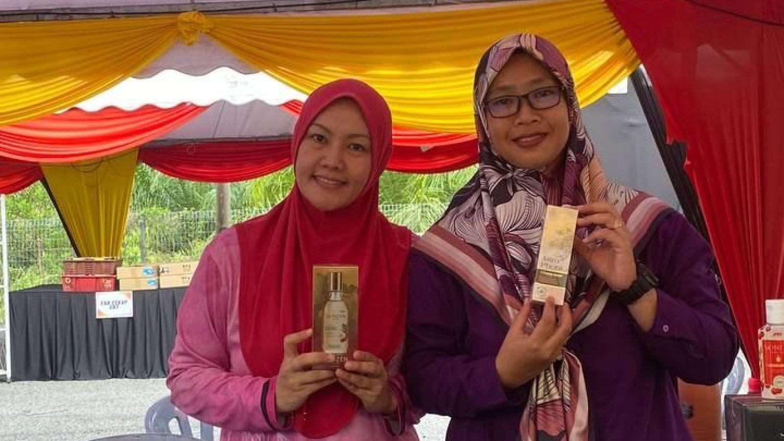 A distributor arranging labelled JRM products at a booth